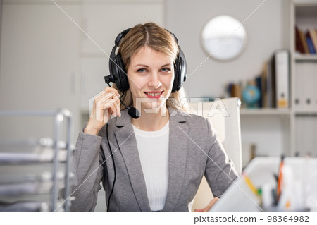 Woman customer support phone operator Woman customer support phone operator 98364982