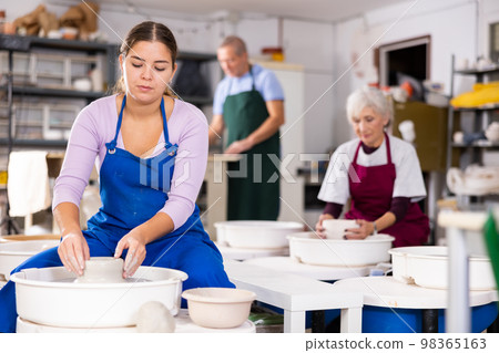 girl works with potter`s wheel 98365163