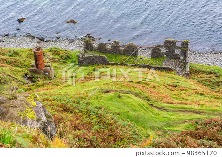 Remains of the drying shed and chimney of diatomite works on the Lealt coast in the Isle of Skye, Scotland. 98365170
