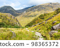 Footpath surrounded by hillside in the Steall Gorge in Glen Nevis near Fort William, Highland, Scotland. 98365372