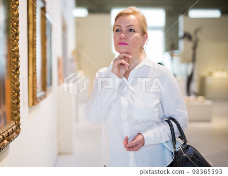 Closeup on mature female visiting museum 98365593