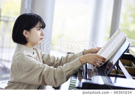 Young Japanese woman playing the piano Young Japanese woman playing the piano 98365834