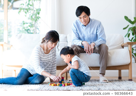 A young family relaxing in the living room A young family relaxing in the living room 98366643