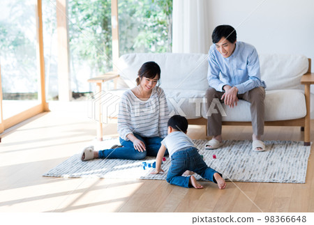 A young family relaxing in the living room A young family relaxing in the living room 98366648