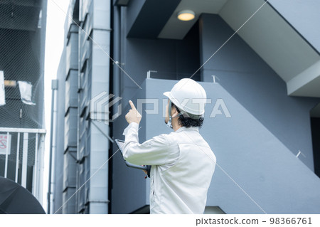 Man in work clothes Building maintenance Man in work clothes Building maintenance 98366761