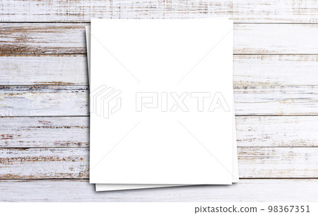 Top view with white paper on wooden table background Top view with white paper on wooden table background 98367351