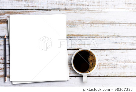 Top view with white paper,pencil and cup of coffee on wooden table Top view with white paper,pencil and cup of coffee on wooden table 98367353