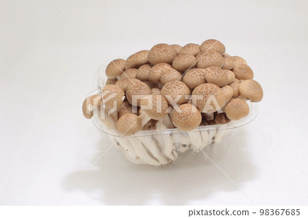brown shimeji mushroom with plastic package 98367685