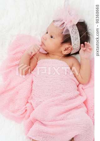 newborn baby girl in blanket on bed newborn baby girl in blanket on bed 98368668