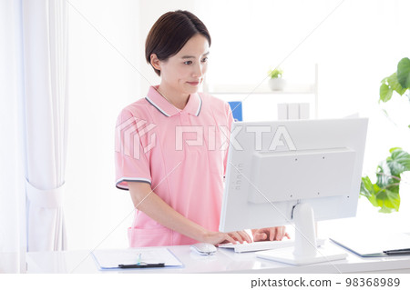 caregiver looking at a computer 98368989