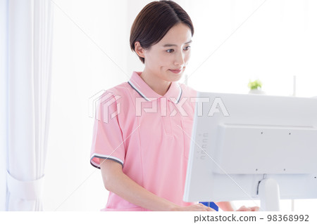 caregiver looking at a computer 98368992
