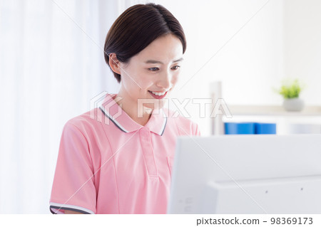 caregiver looking at a computer 98369173
