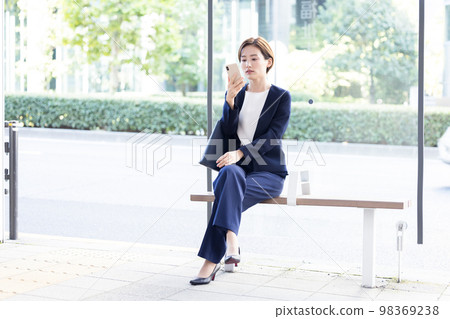Portrait of a woman with a business smartphone Portrait of a woman with a business smartphone 98369238