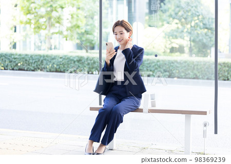 Portrait of a woman with a business smartphone Portrait of a woman with a business smartphone 98369239