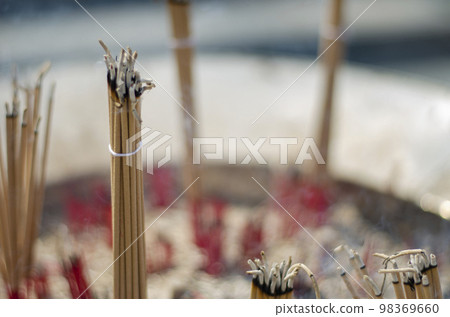 Burning incense sticks in a pot. Incense for praying Buddha or Hindu gods to show worship. bless the holy Burning incense sticks in a pot. Incense for praying Buddha or Hindu gods to show worship. bless the holy 98369660