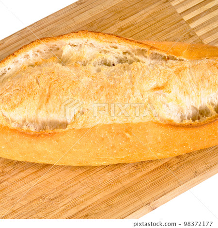 Fresh nutritious and golden colored bread, on a bamboo cutting board Fresh nutritious and golden colored bread, on a bamboo cutting board 98372177