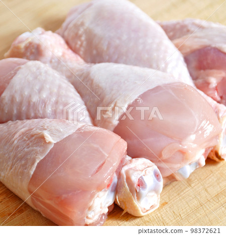 Fresh uncooked chicken meat drumsticks pieces, baget ready to cook 98372621