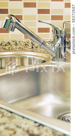 Interior of modern kitchen and stainless steel sink, tap and drain Interior of modern kitchen and stainless steel sink, tap and drain 98372687