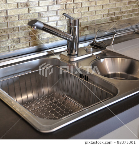 Interior of modern kitchen and stainless steel sink, tap and drain Interior of modern kitchen and stainless steel sink, tap and drain 98373301
