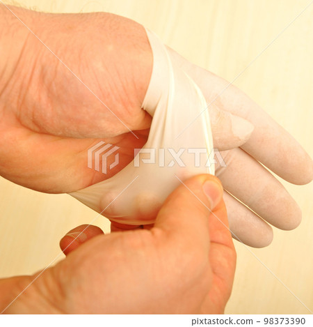 Male doctor hand in white surgical glove, medical latex glove 98373390