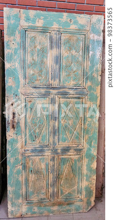 Traditional handmade wooden door in near plan Traditional handmade wooden door in near plan 98373565