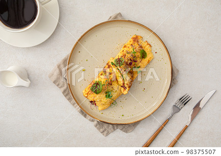 Portion of omelette with avocado and salmon 98375507