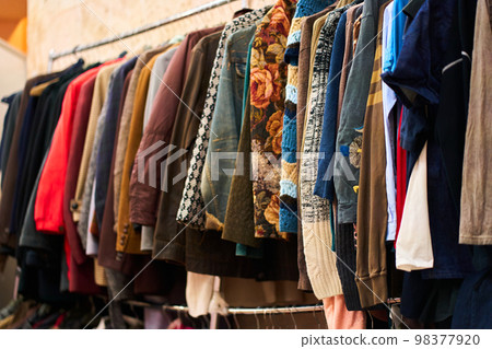Hanger with free clothes in humanitarian centre. Hanger with free clothes in humanitarian centre. 98377920