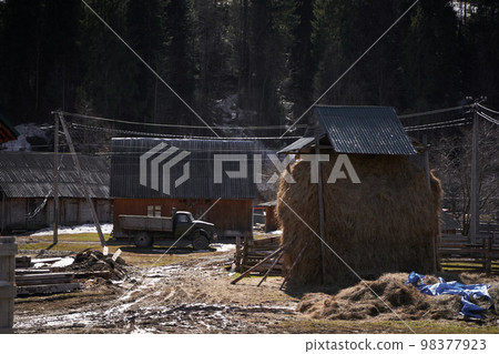 Village landscape mud yard and hay stack. Village landscape mud yard and hay stack. 98377923