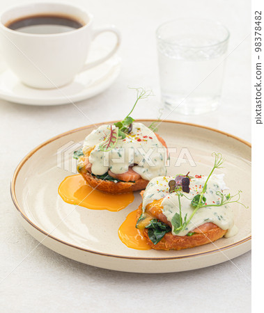 Portion of benedikt egg with dor-blue sauce 98378482
