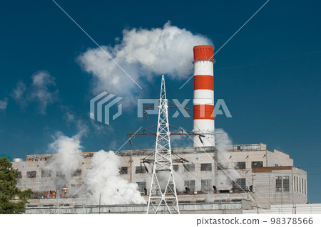 The pipe of the industrial plant emits toxic smoke into the atmosphere and air. Pollution of the environment and ecology. Thermal power plant power lines high voltage 98378566