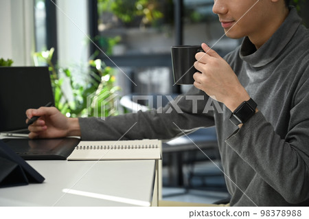 Cropped shot young man software developer working with coded data in his workstation 98378988