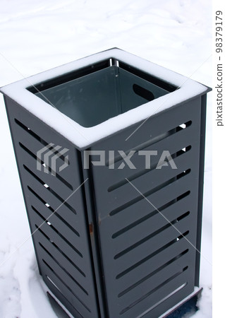 Street trash can among the snow closeup Street trash can among the snow closeup 98379179
