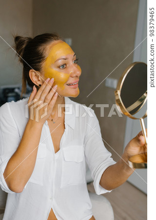 Spa beauty organic facial mask application at day spa home 98379465