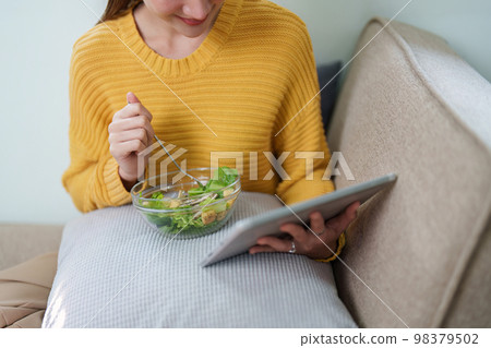 young attractive asian woman in eating salad. vegetables, tomatoes, cabbage, lettuce, cucumbers on table cooking healthy vegetable salad, healthy food active life young attractive asian woman in eating salad. vegetables, tomatoes, cabbage, lettuce, cucumbers on table cooking healthy vegetable salad, healthy food active life 98379502