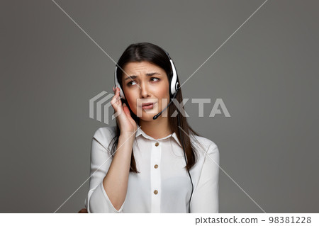 friendly smiling woman with headset is consulting clients online. 98381228