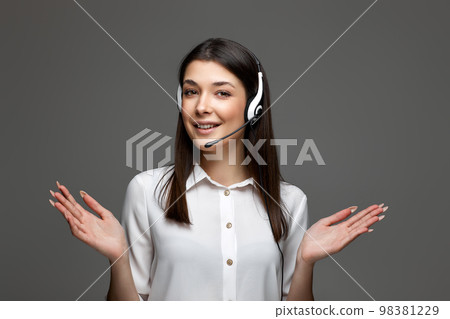 friendly smiling woman with headset is consulting clients online. 98381229