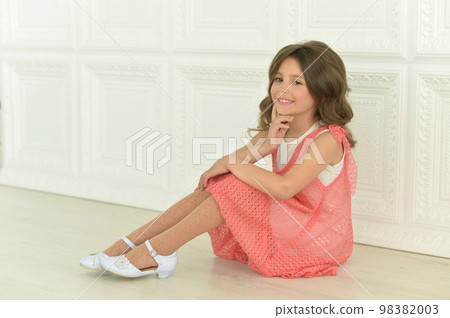 Beautiful happy girl sitting on the floor at home Beautiful happy girl sitting on the floor at home 98382003