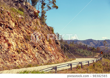 Winding mountain road in spring on a sunny day. Portugal, Europe Winding mountain road in spring on a sunny day. Portugal, Europe 98382565