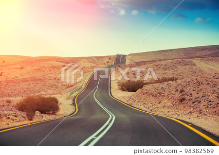 Driving a car on mountain Israel road. Desert landscape. Empty road Driving a car on mountain Israel road. Desert landscape. Empty road 98382569