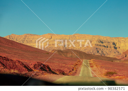 Driving a car on mountain Israel road. Desert landscape. Empty road Driving a car on mountain Israel road. Desert landscape. Empty road 98382571