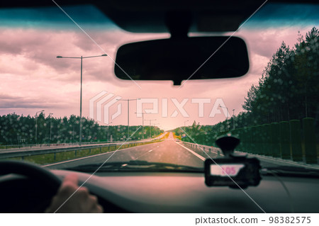 Driving on the Autobahn at sunset in rainy weather 98382575