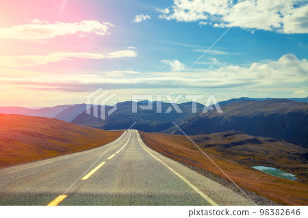 Driving a car on a mountain road. Beautiful harsh nature of Northern Norway Driving a car on a mountain road. Beautiful harsh nature of Northern Norway 98382646