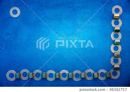 Abstract grunge background. Metallic rings washers on blue grunge wooden background Abstract grunge background. Metallic rings washers on blue grunge wooden background 98382757