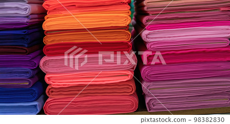 Layers of colorful fabric, colorful background. Pile of bright rolls of fabric. Layers of colorful fabric, colorful background. Pile of bright rolls of fabric. 98382830