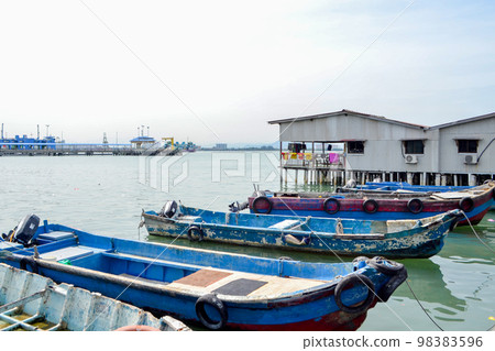 rustic asian fishing port with boats 98383596