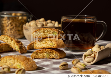 Biscotti Cantuccini Cookie Biscuits with pistachios and lemon peel Shortbread. Cup of tea. Teatime break Healthy eating food. Homemade fresh Italian cookies cantucci stacks and organic pistachios Biscotti Cantuccini Cookie Biscuits with pistachios and lemon peel Shortbread. Cup of tea. Teatime break Healthy eating food. Homemade fresh Italian cookies cantucci stacks and organic pistachios 98383632