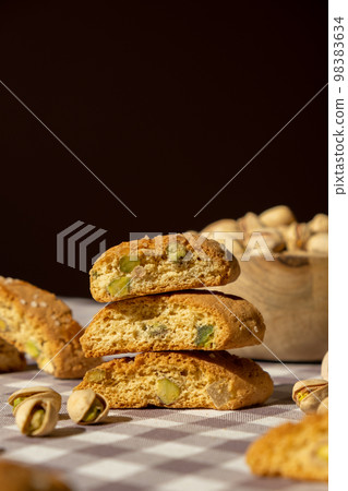 Biscotti Cantuccini Cookie Biscuits with pistachios and lemon peel Shortbread. Healthy eating food. Homemade fresh Italian cookies cantucci stacks and organic pistachios nuts. Vegan dieting Biscotti Cantuccini Cookie Biscuits with pistachios and lemon peel Shortbread. Healthy eating food. Homemade fresh Italian cookies cantucci stacks and organic pistachios nuts. Vegan dieting 98383634