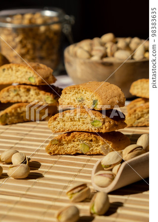 Biscotti Cantuccini Cookie Biscuits with pistachios and lemon peel Shortbread. Healthy eating food. Homemade fresh Italian cookies cantucci stacks and organic pistachios nuts. Vegan dieting Biscotti Cantuccini Cookie Biscuits with pistachios and lemon peel Shortbread. Healthy eating food. Homemade fresh Italian cookies cantucci stacks and organic pistachios nuts. Vegan dieting 98383635