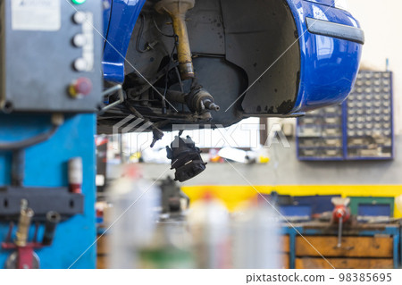 Car service center concept, vehicle raised on lift at maintenance station, auomobile repair, check up, repairing the car 98385695