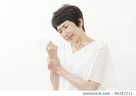 Middle-aged woman with tendonitis white background 98387211
